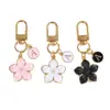Moda simples de best-seller da Amazon transfronteiriça, material de liga, tinta em pó de pérola, pingente de flor de cerejeira para bolsas e malas