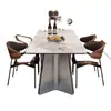 Mesa de comedor con tablero de piedra brillante 2026, un conjunto lujoso y moderno minimalista, adecuado para apartamentos pequeños y salas de estar de estilo italiano, perfecto para comer