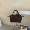 Bolso blanco de estilo minimalista para mujer, bolso de hombro de alta gama para el trabajo, bolso cruzado, bolso tipo dumpling, bolso tote pequeño para el trabajo y artículos varios