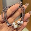 Versão coreana de corda de cabeça de pérola de alta elasticidade 2024 novo pequeno acessório de joia de Yiwu para meninas na parte de trás da cabeça com um elástico de rabo de cavalo
