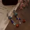 Pendientes Largos Personalizados de la Fábrica Jinqi Estilo Chino Nuevo Flor Pequeña Hueco Azul Quemado Borla para Mujer Pendientes Estilo Étnico Vintage