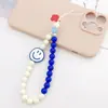 Cadena para teléfono móvil con cuentas acrílicas, moderna y con diseño de emoticono, colgante resistente a caídas para mujer