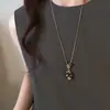 Collar largo de ojo de tigre dorado y perlas para mujer, de alta gama, lujo ligero, cadena para suéter de nicho, 2026, muy bonito