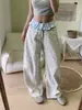 Estilo moderno de dos piezas con una falda superpuesta azul y jeans de pierna curva con estampado de leopardo para mujer, con un diseño holgado, de pierna ancha y largo hasta el suelo