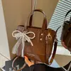 Bolso pequeño súper popular para el trabajo, bolso de hombro tejido para mujer nuevo de verano 2026, bolso cruzado tipo cubo para ir al trabajo