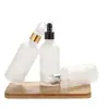 Venta al por mayor de fábrica botella transparente esmerilada de 30 ml para aceite esencial botella cosmética nueva botella con gotero de cabeza de plástico Botella secundaria para loción