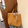 Bolsa de ombro casual, novo modelo transfronteiriço, grande capacidade, bolsa tote lisa simples, versão coreana, bolsa de lona versátil para o dia a dia