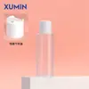En Stock Xumin 100-150ml Hombro Plano Transparente Escarchado Botella de Tónico Agua Pura Botella con Tapa Blanca Transparente Azul