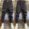 Nuevos pantalones casuales ajustados combinables para hombre, tendencia de otoño, pantalones deportivos elásticos de sudoración, pantalones tipo harén holgados elásticos