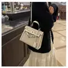 Bolsos estilo nuevo candado bolso Kelly, bolso de mano de moda europeo y americano con bloques de color para mujer, bolso cruzado de hombro texturizado y empalmado