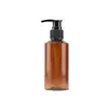 Frasco plástico de pressão de 150ml embalagem para produtos de higiene pessoal frasco de shampoo loção frasco com bomba de pressão de ombro inclinado atacado