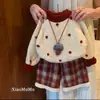 Conjunto de ropa de invierno para niña 2026 nuevo estilo Atuendo de Año Nuevo suéter grueso para bebé pantalones de cuadros coreanos ropa nueva festiva de Año Nuevo