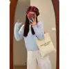 Estilo suave y relajado, cárdigan de punto morado con cuello redondo para mujer, nueva colección otoño/invierno 2026, moderno y único, un top corto muy elegante