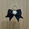 Lazo Negro de Satén Tejido a Mano Anillo de Resorte Metálico Broche Colgante Decorativo para Bolsos y Zapatos DIY