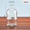 Botella de reactivo de boca ancha al por mayor, botella de vidrio con tapón de corcho, botella sub-botella de medicina de laboratorio, botella transparente sellada de boca ancha al por mayor