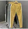 Nueva colección de primavera y otoño: pantalones casuales a rayas de bloques de color para hombre, modernos y elegantes, de pierna recta de alta gama, corte ajustado y deportivos largos