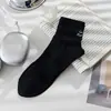 Meias primavera e outono masculinas cor sólida algodão novas fundo massageador bordado esportivo cano médio cano curto meias masculinas atacado