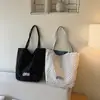 Bolsa de mano tipo tote para el trabajo, diseño de nicho nuevo de primavera, estilo femenino, gran capacidad, simple, moderna, casual, personalizada, de un solo hombro