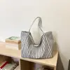 Bolso tote de rayas de alta gama japonés y coreano transfronterizo, nuevo bolso versátil para el hombro y debajo del brazo 2026, bolso de mano de gran capacidad