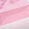 Bolsa de papel tipo tote sin cintura con patrón de lazo de pedrería en forma de corazón, estilo juvenil, adecuada para compras de cosméticos y empaque de regalos