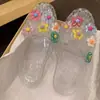 Zapatos de gelatina de moda para mujer, estilo coreano, zapatos destalonados con accesorios florales, medios zuecos planos, chanclas de playa transparentes de cristal