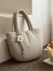 Nueva colección Otoño/Invierno 2026: Bolso de mano minimalista de color liso para mujer, bolso tote pequeño, adecuado para el trabajo y los desplazamientos, bolso acolchado de algodón estilo coreano