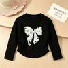Nueva colección de Primavera y Otoño: Camisetas básicas de manga larga con cuello redondo para niñas, con lindos estampados de moños, disponibles al por mayor