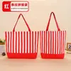 Bolsa de lona com retalhos listrados exclusiva transfronteiriça, bolsa tote de lona com blocos de cor para carregar na mão, pedidos de comércio exterior podem ser personalizados com impressão