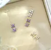 Pendientes Populares Transfronterizos Europeos y Americanos de Plata de Ley S925 Incrustados con Circonita Púrpura de Flor de Cuatro Hojas para Mujeres Ins Pequeños, Simples y de Alta Gama