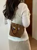Bolso cubo estilo francés para mujer, nuevo bolso de hombro color-blocking de moda 2026, bolso de mano de nicho para el día a día, bolso pequeño cruzado para damas