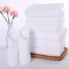 Toalla Blanca Desechable Transfronteriza Toalla de Baño de Hotel Logo Personalizado Suave Absorbente Engrosada Toalla Pequeña Blanca de Hotel