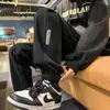 Suministro directo de fábrica pantalones grises con puntera para hombre primavera y otoño costuras INS pantalones deportivos marca de moda pantalones casuales holgados