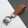 Colgante Llavero de Coche de Cuero Gamuzado Anillo de Resorte de Aleación de Zinc Cubierta de Llave Cadena de Llave con Logo de Coche Venta al por Mayor