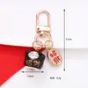 Estilo Chino Atrae Fortuna Cerámica Gato de la Suerte Llavero Colgante Estuche para Auriculares Bolso Encanto Accesorio Adornos Pequeños Venta al por Mayor