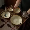 Juego de vajilla rústica de cerámica estilo japonés para una persona, con una combinación retro de cuenco y plato, adecuado para uso doméstico, incluyendo cuencos de arroz de cerámica, cuencos de sopa y platillos para condimentos, disponible para venta al por mayor