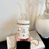Bolsa pequeña cilíndrica con estampado de dibujos animados para mujer, nueva temporada 2026, bolso cubo vintage de alta gama, moda versátil para mujer