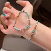 Pulsera elástica popular estilo étnico turquesa de Xiaohongshu, nuevo estilo chino, método antiguo, diseño que ilumina la piel, joyería de cuentas, venta al por mayor de una sola pieza