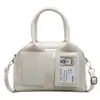 Moda Brillante de Primavera 2025 Cara Brillante Color Sólido Coreano Bolso Boston Portátil Diseño de Nicho Bolso de Hombro Cruzado