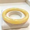 Imitação de fábrica pulseira de jade pulseira de vidro pagamento de dívidas Jade barra redonda leite amarelo jade pulseira tenda Jade 10 yuan modelo