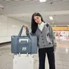 2025 bolsa de almacenamiento para ropa de mudanza acolchada de doble capa transfronteriza bolsa de equipaje portátil con ruedas al por mayor