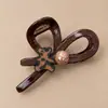 Pinza de pelo pequeña con garra para temperamento de princesa, pinza de pelo lateral estilo coreano exquisita, sensación de alta gama, nuevo pinza de pelo para media coleta 2026