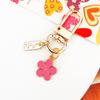 Llavero de metal de gran oferta transfronteriza, colgante de bolso con flores pequeñas, accesorios de joyería, llavero estilo Ins de Corea del Sur.