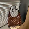 Bolsa casual de lunares de alta calidad para mujer 2026 nueva bolsa de mano de gran capacidad versátil para ir al trabajo bolsa de un solo hombro para el antebrazo