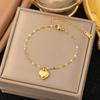 Pulsera de acero inoxidable de alta gama para nicho de venta caliente transfronteriza que no se desvanece, pulsera de trébol de cuerda roja perla para niña, joyería