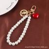 Nueva pulsera creativa de perlas con bonito colgante de aleación de corazón, llavero con cabeza de belleza, accesorios de metal, bolso de joyería para mujer
