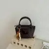 Bolsa de Tecido Nova da Moda para Primavera/Verão 2026 Bolsa de Mão Estilo Balde de Alta Qualidade Versátil Tendência Bolsa de Ombro Transversal