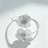 Pulsera de diseño de moda transfronteriza de Amazon con diseño floral y puño abierto para mujer, con un estilo urbano único y líneas caladas