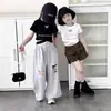 Ropa Infantil Nueva y Elegante para Niñas Verano 2026, Camiseta con Letras Estilo Coreano, Corte Ajustado, Crop Top, Diseño Cruzado, Manga Corta