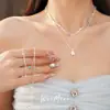 Collar de cuentas de piedra de doble capa con estrellas de circonita y perlas, cadena para la clavícula de nicho de lujo ligero, accesorio elegante y versátil para el día a día