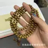 Pulseras de nanmu con borde dorado de una sola vuelta con cuentas de Buda pulseras de moda casual para hombres y mujeres con el mismo estilo pulseras literarias de juego salidas de fábrica